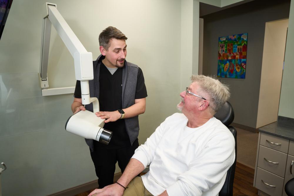 Man sitting in the dental chair for full mouth reconstruction