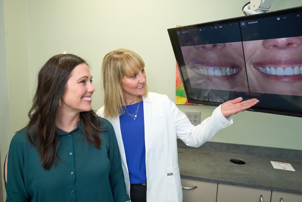 dentist showing the images of patients teeth in a monitor
