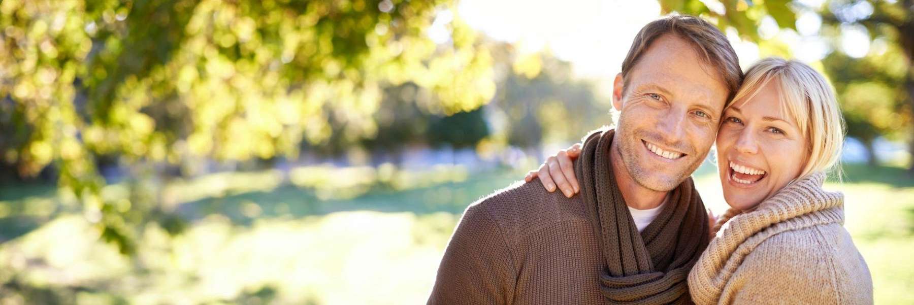 man and woman smiling in a evansville park