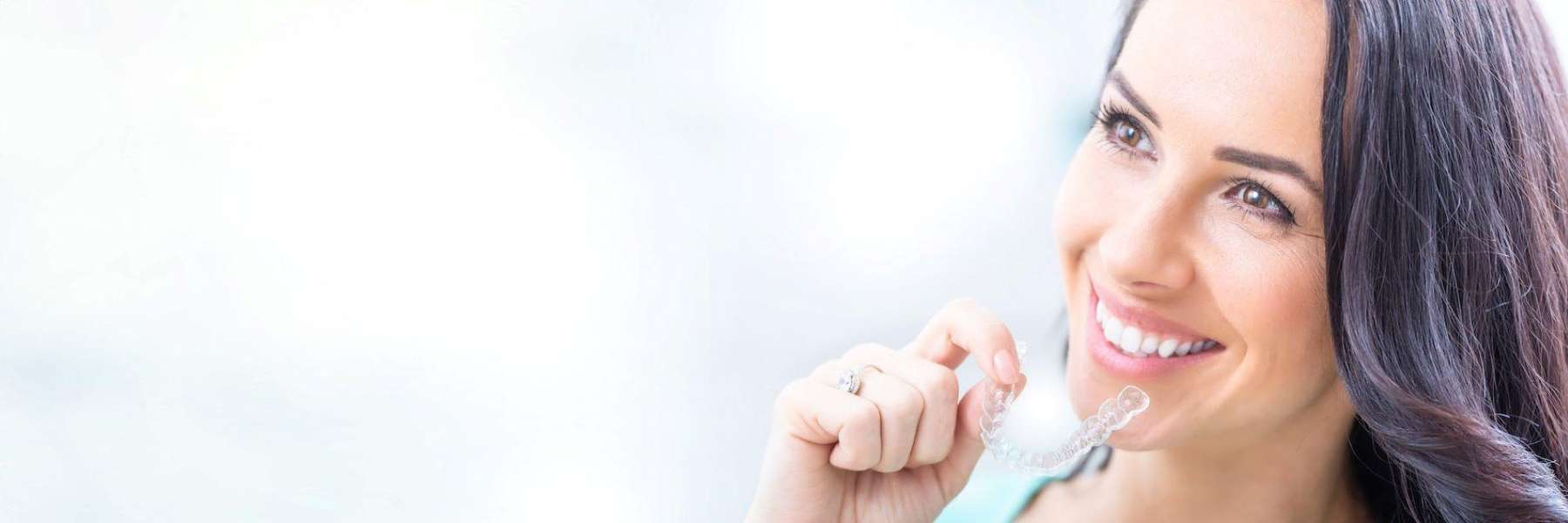 Woman holding clear aligner